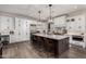 A modern kitchen with a large island, stainless steel appliances, and custom cabinetry at 11385 N Luckenbach St, Surprise, AZ 85388