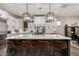 A spacious kitchen boasts white cabinets, a large center island, and pendant lighting above the breakfast bar at 11385 N Luckenbach St, Surprise, AZ 85388