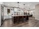 Spacious kitchen featuring an oversized island, modern lighting, and seating for four at 11385 N Luckenbach St, Surprise, AZ 85388