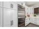 A kitchen with stainless steel refrigerator and modern cabinets at 11385 N Luckenbach St, Surprise, AZ 85388