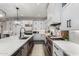 Modern kitchen featuring quartz countertops, stainless steel appliances, and sleek white cabinetry at 11385 N Luckenbach St, Surprise, AZ 85388