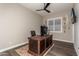 Home office with desk, ceiling fan, wood floors, and decorative tennis rackets on display at 11385 N Luckenbach St, Surprise, AZ 85388