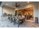 Outdoor patio with dining table, grill, pizza oven, and a view into the living room at 11385 N Luckenbach St, Surprise, AZ 85388