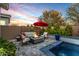 Outdoor patio with comfortable seating, a fire pit, and views of the pool at 11385 N Luckenbach St, Surprise, AZ 85388