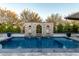 Backyard pool featuring stone accents, lighting, and manicured landscaping creates a relaxing outdoor oasis at 11385 N Luckenbach St, Surprise, AZ 85388