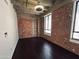 Large bedroom features exposed brick, concrete ceilings, hardwood floors and plenty of natural light at 114 W Adams St # 302, Phoenix, AZ 85003
