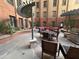 Outdoor community courtyard with multiple tables and chairs for residents to use at 114 W Adams St # 302, Phoenix, AZ 85003
