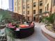 Outdoor community courtyard with comfortable seating arrangements and shade pergolas at 114 W Adams St # 302, Phoenix, AZ 85003
