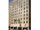 The exterior showcases the architectural design and numerous windows of the building at 114 W Adams St # 302, Phoenix, AZ 85003