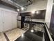 Compact kitchen featuring stainless steel appliances, dark cabinetry, and black countertops at 114 W Adams St # 302, Phoenix, AZ 85003