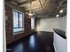 Bright living room with hardwood floors, exposed brick, and industrial-style lighting at 114 W Adams St # 302, Phoenix, AZ 85003