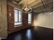 Bright living room featuring hardwood floors, exposed brick, and industrial lighting at 114 W Adams St # 302, Phoenix, AZ 85003