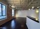 Spacious living area with exposed brick, hardwood floors, and industrial-chic lighting at 114 W Adams St # 302, Phoenix, AZ 85003