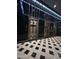 A building lobby with decorative elevators and a black and white geometric floor at 114 W Adams St # 302, Phoenix, AZ 85003