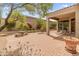 Picturesque backyard with brick pavers, mature landscaping, patio furniture, and views at 11490 E Beck Ln, Scottsdale, AZ 85255