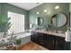 Stylish bathroom with a soaking tub, decorative plants, and granite countertops at 11490 E Beck Ln, Scottsdale, AZ 85255