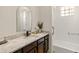 Bathroom with granite countertop, stylish mirror and black cabinetry at 11490 E Beck Ln, Scottsdale, AZ 85255