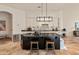 Beautiful kitchen with an island, stone countertops, and wooden stools at 11490 E Beck Ln, Scottsdale, AZ 85255