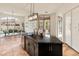 Bright kitchen with a black countertop island, stainless steel appliances, and access to the patio at 11490 E Beck Ln, Scottsdale, AZ 85255