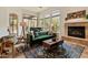 Charming living room with a fireplace, cozy furniture, and backyard access at 11490 E Beck Ln, Scottsdale, AZ 85255