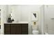 Bathroom featuring a dark vanity, toilet, framed art, and shower/tub with curtain at 11946 W Calle De Pompas --, Peoria, AZ 85383