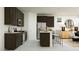 Modern kitchen featuring dark cabinets, stainless steel appliances, and bar seating at 11946 W Calle De Pompas --, Peoria, AZ 85383