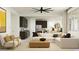 Open-concept living room featuring a modern sofa, stylish decor, and an adjacent kitchen area at 11946 W Calle De Pompas --, Peoria, AZ 85383