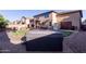 A backyard with a covered hot tub, hardscape, and space for entertaining at 12226 W Planada Ln, Sun City, AZ 85373