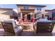 Outdoor area featuring a fire pit, seating, and lush landscaping for relaxed entertaining at 12226 W Planada Ln, Sun City, AZ 85373