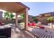 Backyard patio features a covered area and plenty of seating, great for entertaining at 12226 W Planada Ln, Sun City, AZ 85373