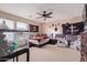 This carpeted bedroom has a ceiling fan, two windows, and themed décor and furniture at 12226 W Planada Ln, Sun City, AZ 85373