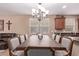 Dining room featuring large dining table, chandelier, and large window with view of backyard at 12226 W Planada Ln, Sun City, AZ 85373
