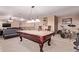 Spacious game room featuring a billiard table, seating area, and a drum set for entertainment at 12226 W Planada Ln, Sun City, AZ 85373