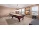 Spacious game room with a pool table and ample lighting, perfect for entertainment at 12226 W Planada Ln, Sun City, AZ 85373