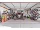 This well-organized garage has tools, a UTV, and bikes hanging from the ceiling at 12226 W Planada Ln, Sun City, AZ 85373