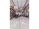 This spacious garage features a boat inside, organized shelving, and overhead lights at 12226 W Planada Ln, Sun City, AZ 85373