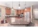 Well-lit kitchen with stainless steel appliances, granite countertops, and recessed lighting at 12226 W Planada Ln, Sun City, AZ 85373