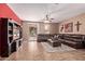 Spacious living room featuring tile flooring, large sectional, ceiling fan, and backyard access at 12226 W Planada Ln, Sun City, AZ 85373