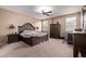 Relaxing main bedroom features a ceiling fan, natural light from windows, and neutral colors for a calm retreat at 12226 W Planada Ln, Sun City, AZ 85373