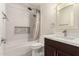Cozy bathroom with decorative backsplash, dark wood vanity, and tiled floors at 12241 N 49Th Ave, Glendale, AZ 85304