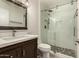 Modern bathroom features a glass-enclosed shower, stylish vanity, and contemporary fixtures at 12241 N 49Th Ave, Glendale, AZ 85304