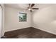 Bedroom with wood flooring, ceiling fan, and window allowing natural light at 12241 N 49Th Ave, Glendale, AZ 85304