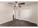 Bedroom features a ceiling fan, wood flooring, ensuite bathroom and closet at 12241 N 49Th Ave, Glendale, AZ 85304