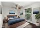 Bright bedroom with hardwood floors, fan, and a window overlooking the exterior at 12241 N 49Th Ave, Glendale, AZ 85304