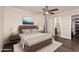 A styled bedroom with wood flooring, ceiling fan, and ensuite bathroom for convenience at 12241 N 49Th Ave, Glendale, AZ 85304