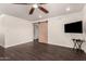 Large bedroom featuring dark hardwood floors and barn door to ensuite at 12241 N 49Th Ave, Glendale, AZ 85304