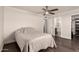 Bedroom featuring a ceiling fan, wood floors, and an ensuite bathroom at 12241 N 49Th Ave, Glendale, AZ 85304