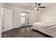 Bedroom features a ceiling fan, dark wood floors, and French doors leading to the outside at 12241 N 49Th Ave, Glendale, AZ 85304