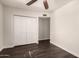 Bedroom featuring hardwood floors, fan, and closet doors at 12241 N 49Th Ave, Glendale, AZ 85304