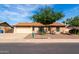 Charming single-story home featuring a well-maintained front yard, mature tree, and a two-car garage at 12241 N 49Th Ave, Glendale, AZ 85304